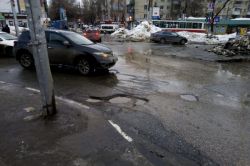 Оживленный перекресток покрылся глубокими выбоинами